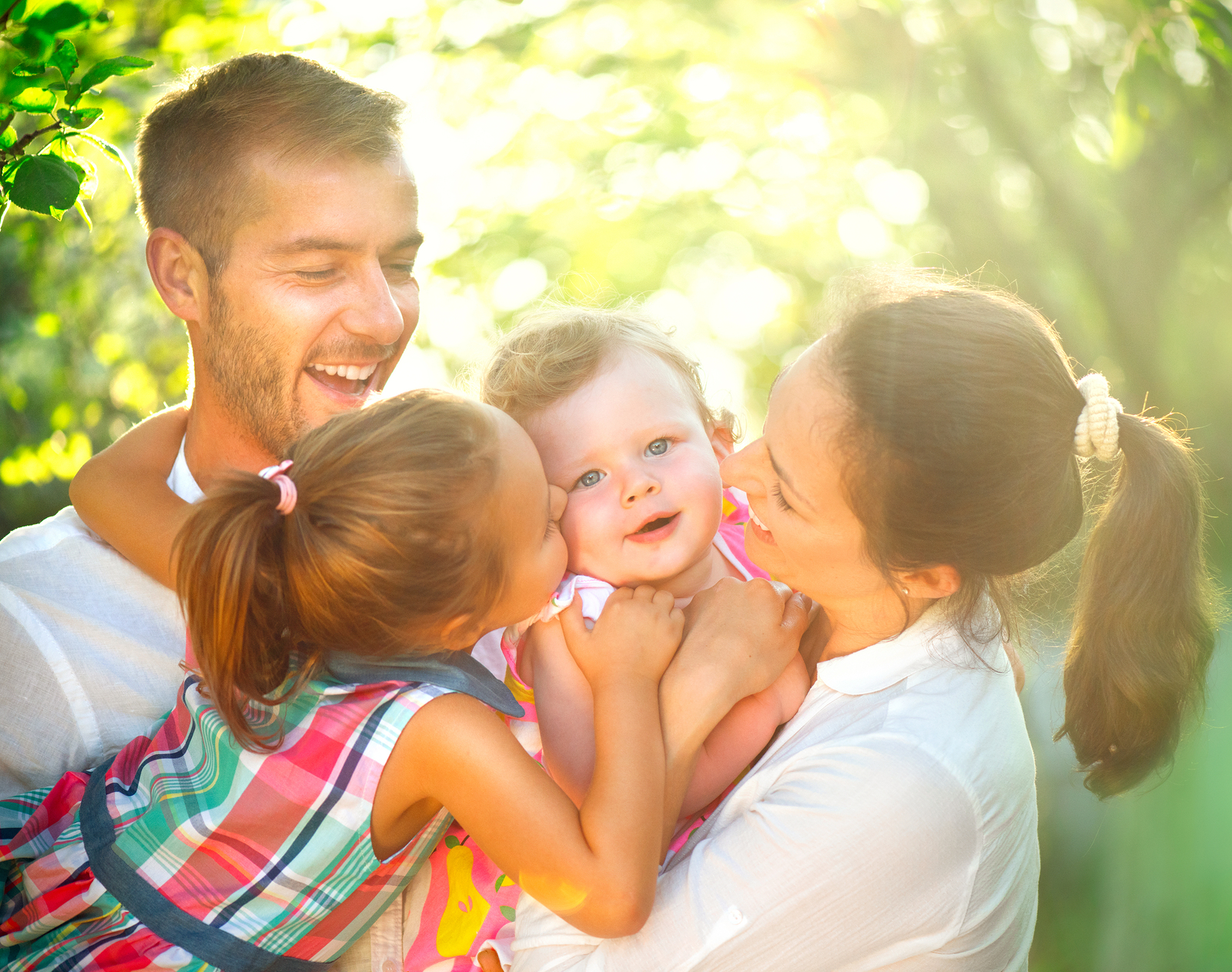 Happy joyful young family with children. Father, mother and litt